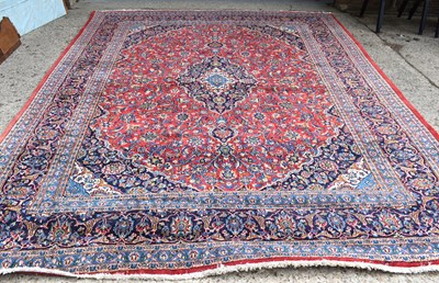 Lot 422 - A large Tabriz woollen carpet, centred by...