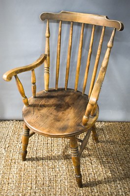 Lot 423 - A Victorian elm kitchen armchair with spindle...