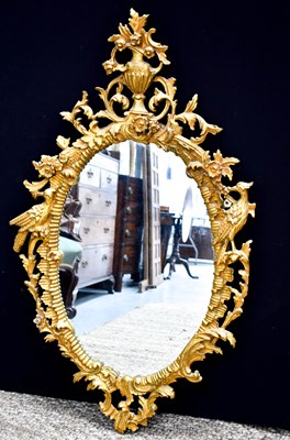 Lot 363 - A 20th century oval carved giltwood wall...