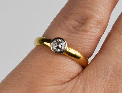 Lot 427 - An 18ct gold and diamond solitaire ring, the...