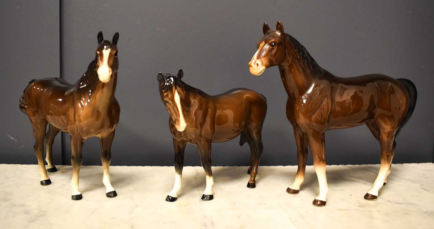 Lot 69 - A collection of three porcelain horses, two...