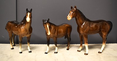Lot 69 - A collection of three porcelain horses, two...