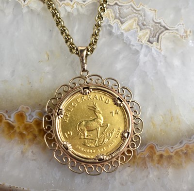 Lot 177 - A 1974 1oz gold Krugerrand, in a scroll mount...