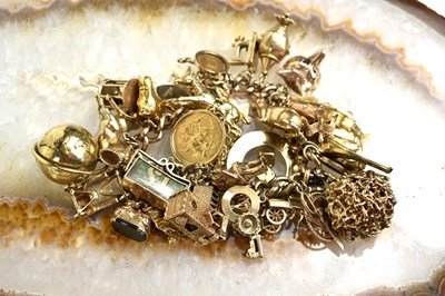 Lot 151 - A 9ct gold charm bracelet, consisting of...