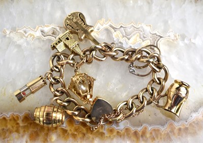 Lot 176 - A 9ct gold charm bracelet with seven charms...