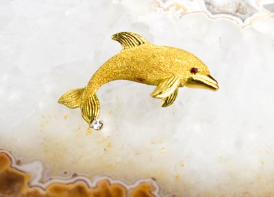Lot 126 - An 18ct gold dolphin brooch with ruby eye and...