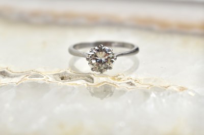 Lot 125 - A platinum solitaire ring set to the centre...