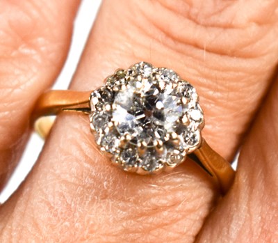Lot 137 - An 18ct gold and diamond cluster ring, the...