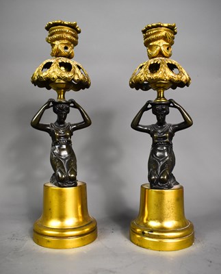 Lot 245 - A pair of bronze figures kneeling holding a...