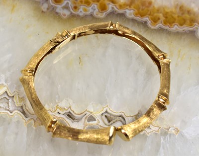 Lot 228 - A 14ct gold bracelet with textured bamboo...