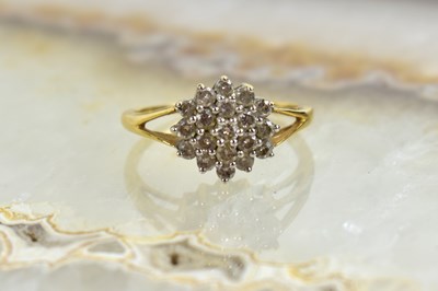Lot 188 - An 18ct gold and diamond cluster ring, set...