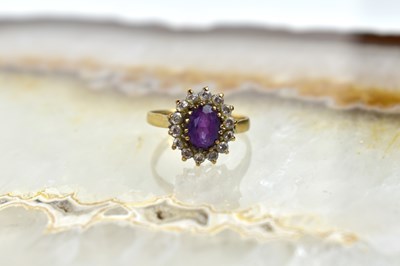 Lot 112 - A 9ct gold, cubic zirconia and amethyst ring,...