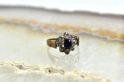 Lot 113 - A 9ct gold, diamond and sapphire flowerhead...