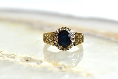 Lot 114 - A 9ct gold, diamond and sapphire cluster ring,...