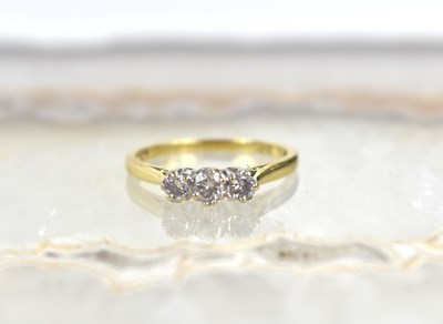 Lot 171 - An 18ct gold and diamond three stone ring,...