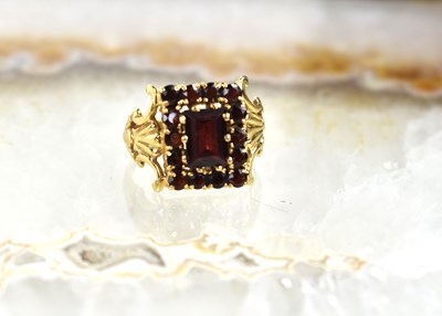 Lot 142 - A 9ct gold and garnet cluster ring of...