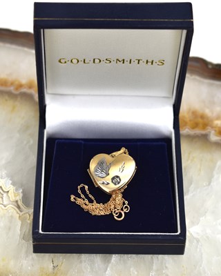 Lot 46 - A 9ct gold heart locket pendant and necklace,...