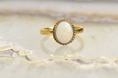Lot 145 - A 9ct gold and opal ring, size N, 4.2g.