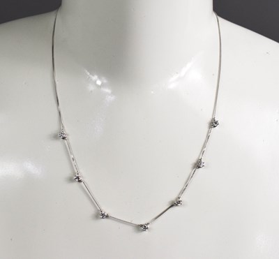 Lot 89 - A 9ct white gold and diamond necklace, the...