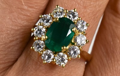 Lot 27 - An 18ct yellow gold, diamond and emerald ring,...