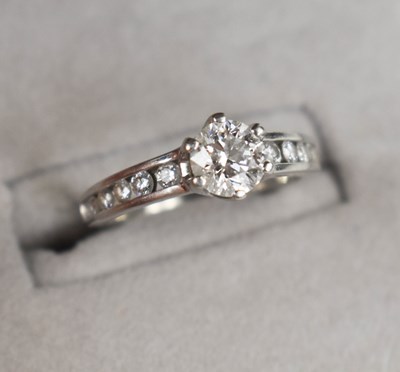 Lot 23 - A platinum and diamond ring, the central...
