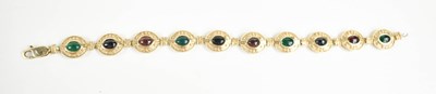 Lot 25 - A 9ct gold, emerald and sapphire cabochon set...