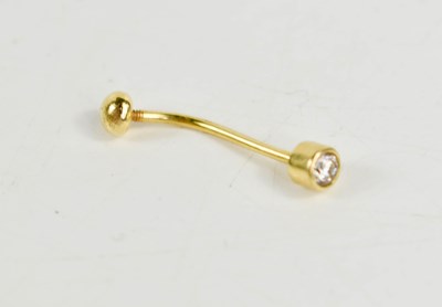 Lot 38 - A gold and diamond belly button ring / stud,...