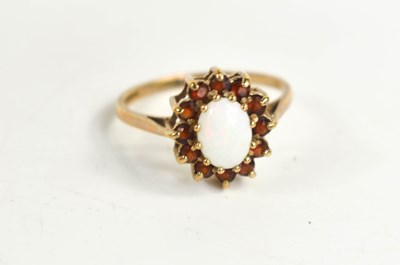 Lot 66 - A 9ct gold, opal and garnet ring, the oval...