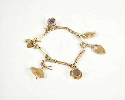 Lot 79 - A 9ct gold charm bracelet, with heart lock...
