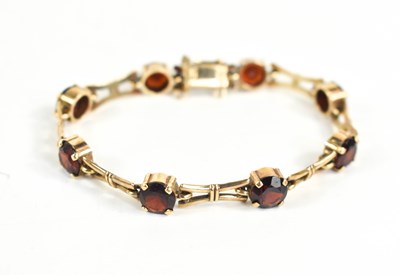 Lot 80 - A 9ct gold and garnet bracelet, the seven...