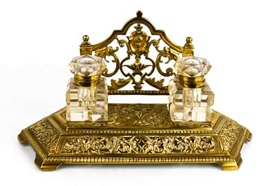 Lot 298 - A 20th century brass inkstand, cast and...