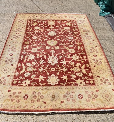 Lot 324 - A 20th century wool rug, cream ground and red...