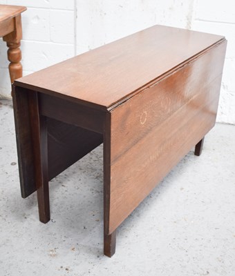 Lot 330 - A late 19th century oak drop leaf table, with...