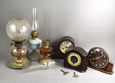 Lot 236 - A selection of antique paraffin lamps, one...