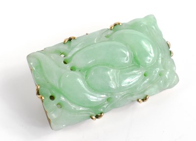 Lot 2 - A 9ct gold and carved jade brooch with safety...