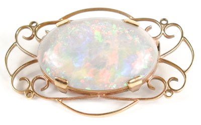 Lot 18 - A 9ct gold and oval opal set brooch, with...