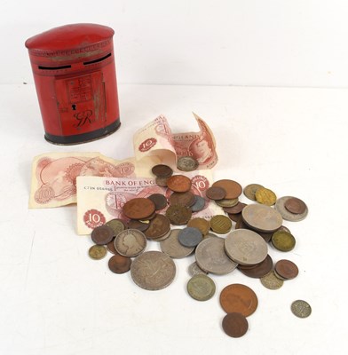 Lot 140 - A group of coins to include three pence pieces,...