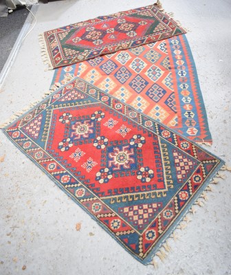 Lot 357 - A group of three Middle Eastern wool rugs, red...