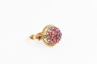 Lot 56 - An 18ct gold and ruby cluster ring, the rubies...