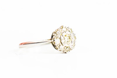 Lot 24 - A platinum and diamond flowerhead ring, the...