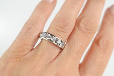 Lot 141 - An 18ct white gold and diamond half hoop...