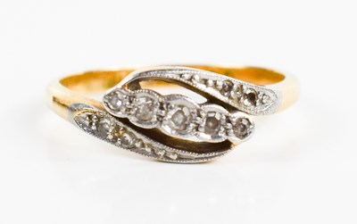 Lot 153 - An 18ct gold and diamond crossover ring, the...