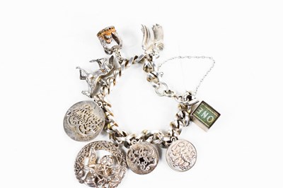 Lot 59 - A sterling silver charm bracelet, with eight...