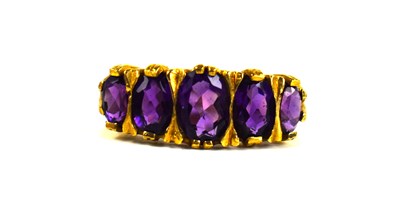Lot 136 - A 9ct gold and amethyst ring, the five oval...