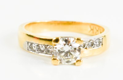 Lot 155 - An 18ct gold and diamond ring, the central...
