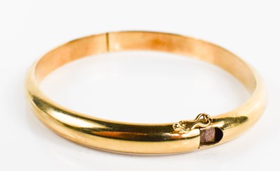Lot 236 - A 9ct gold bangle, with slide clasp and safety...