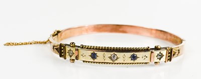 Lot 139 - A Victorian gold bangle, set with mine cut...