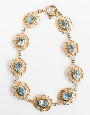 Lot 158 - A 9ct gold and blue topaz bracelet, the links...