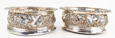 Lot 333 - A pair of silver wine coasters, embossed and...