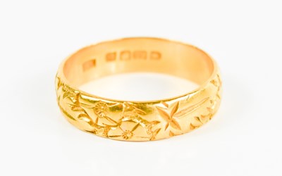Lot 105 - A 22ct gold wedding band, engraved with...